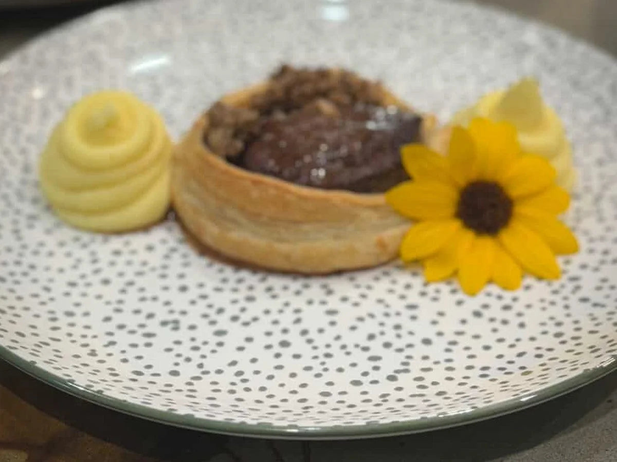 A puff pastry dessert with a sunflower