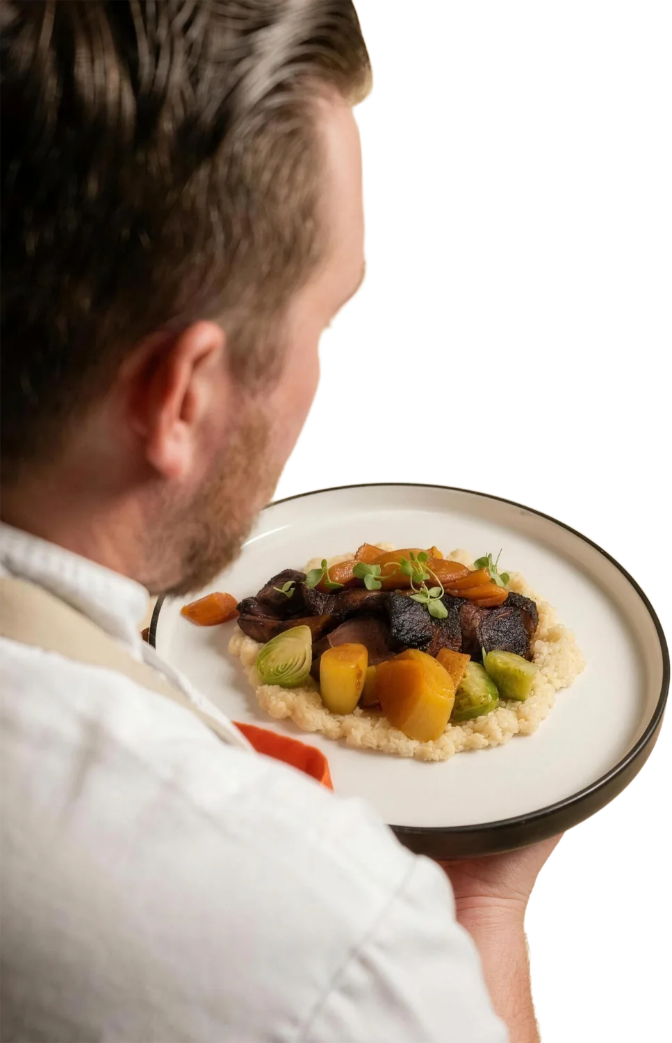 Chef Wade Loucks carrying a plated dish to the table